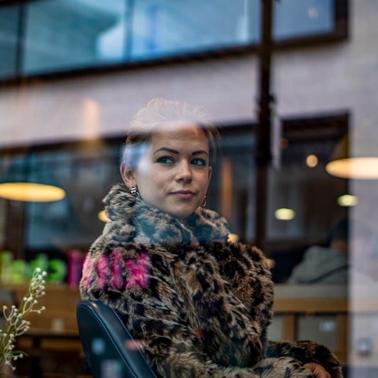 Kaveri Mehta, Lead Design Curator at KitchenCalmHarbor, reviewing corporate floral arrangements